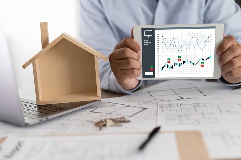 Real estate agent signing a contract over a house key  real esta